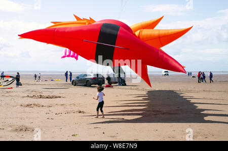 Lytham St Annes on Sea. UK Weather. 9th August, 2019 Strong winds for the weekend Kite Festival in Lytham which has been officially cancelled because of adverse weather, and which has been rescheduled for September.  Teams from Kuwait already based in the seaside town take their Peter Lynn kites to the air to enjoy some flying time before conditions deteriorate. Credit: MediaWorldImages/AlamyLiveNews Stock Photo
