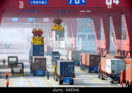 --FILE--Containers are being lifted on a quay at the Port of Qingdao in Qingdao city, east China's Shandong province, 29 December 2014.   China's expo Stock Photo