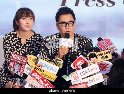 South Korean singer Jeong Soon-won, right, better known by his stage name The One, is interviewed during a press conference for his Chinese album 'Bec Stock Photo