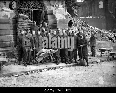 Soldiers and prisoners of war clearing bomb damage from the Haberdashers Hall in London following a German air raid in 1940 Stock Photo