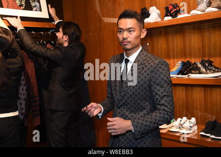Chinese badminton star Lin Dan poses at a signing event for his photo album in Beijing, China, 20 March 2015. Stock Photo