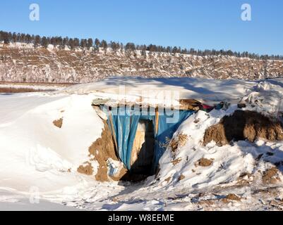 View of the snow-covered cellar of 58-year-old Chinese man Yu Fazhong, where he has been living alone for ten years, near Beiji Village (Arctic Villag Stock Photo