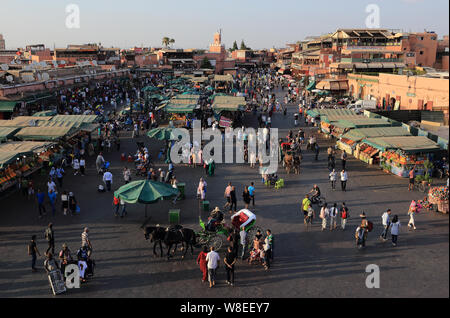 MARRAKESH, MOROCCO. June 26, 2019: Dusk over the Djemma el Fna Square. At night the square turns into a huge open-air restaurant and hive of activity. Stock Photo