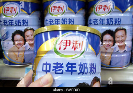 --FILE--A customer shops for a tin of Yili milk powder for middle-aged and elderly people at a supermarket in Nanjing city, east Chinas Jiangsu provin Stock Photo