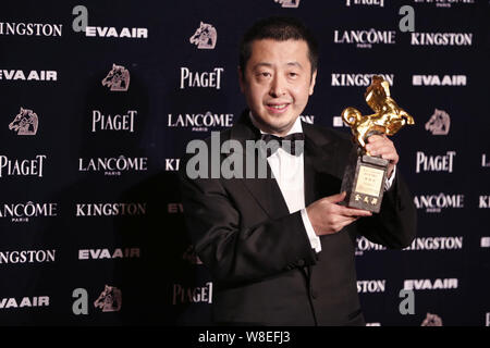 Chinese director Jia Zhangke poses with his trophy for Best Original Screenplay award for his movie 'Mountains May Depart' during the 52nd Golden Hors Stock Photo