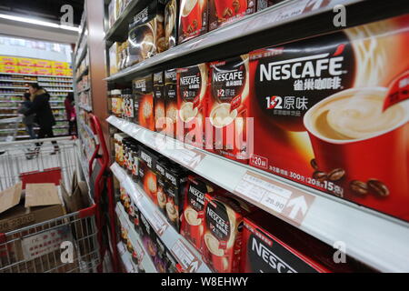 --FILE--Cartons of Nescafe instant coffee of Nestle are for sale at a supermarket in Xuchang city, central Chinas Henan province, 7 December 2014. Stock Photo
