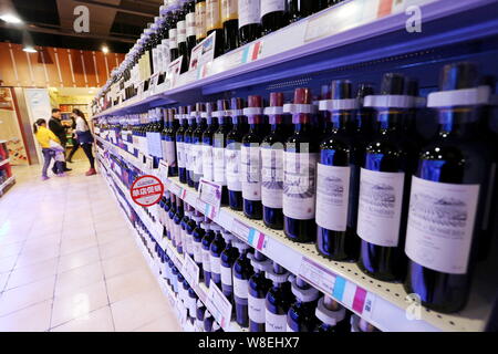 --FILE--Bottles of red wine imported from France are for sale at a supermarket in Xuchang city, central China's Henan province, 16 November 2014.   Sa Stock Photo