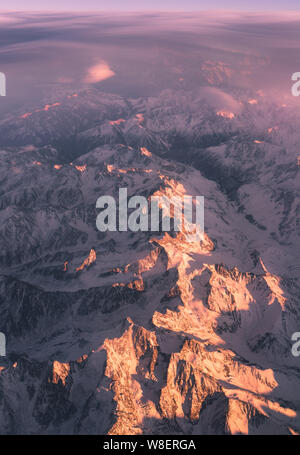 Clouds and sunset plane window view in Caucasus Stock Photo