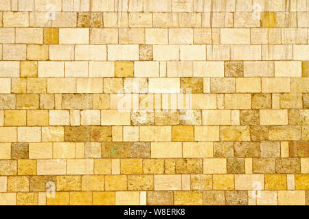 Big yellow wall made from stone bricks Stock Photo