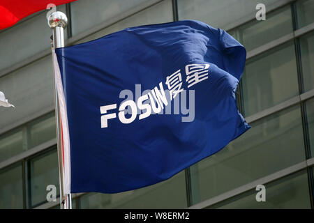 --FILE--A flag of Fosun flutters at the headquarters of Fosun Group in Shanghai, China, 20 February 2014.   Chinese conglomerate Fosun International L Stock Photo