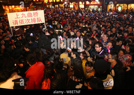 --FILE--Tourists crowd Yu Garden, or Yuyuan Garden, to enjoy traditional Chinese lanterns on the Lantern Festival in Shanghai, China, 14 February 2014 Stock Photo
