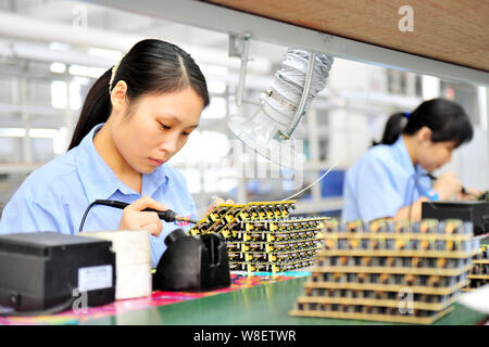 --FILE--Female Chinese workers produce electronic products on the ...