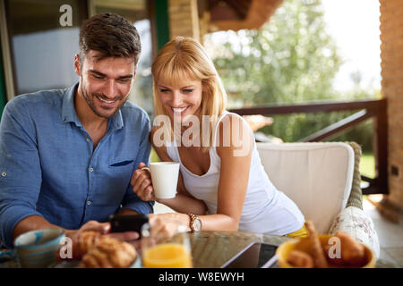 Young couple having breakfast outdoor Stock Photo