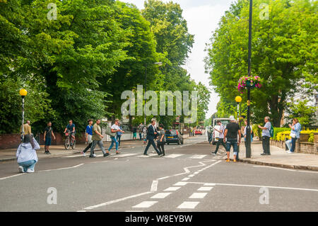 Tourists following in the footsteps of the Beatles on the pedestrian ...