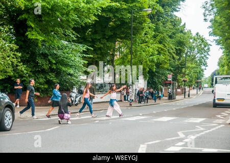 Tourists following in the footsteps of the Beatles on the pedestrian ...