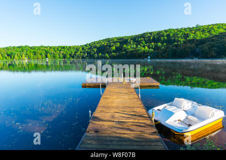 dock overlooking the quiet lake in the morning Stock Photo