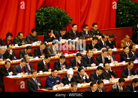 The 11th Panchen Lama Bainqen Erdini Qoigyijabu (or Erdeni Gyaincain Norbu), in red, and other delegates attend the opening session for the Third Sess Stock Photo