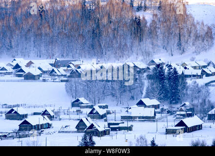 Landscape of houses near the Kanas Lake in the snow in Altay Prefecture, southwest China's Xinjiang Autonomous Region, 28 December 2008. Stock Photo