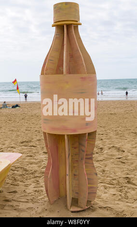 Bournemouth, Dorset UK. 9th Aug 2019. A new temporary art installation arrives at Bournemouth beach comprising of a takeway box, plastic cutlery and single use plastic bottle all made out of wood with messages about plastic pollution and its effect on wildlife. Designed by artist Jack Raisey similar installations have been installed on beaches at Lyme Regis and West Bay.  Credit: Carolyn Jenkins/Alamy Live News Stock Photo