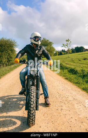 Man with helmet riding custom motorbike Stock Photo