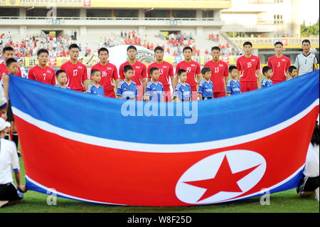 Players of the starting line-up of North Korea sing the North Korean national anthem before their soccer match of the Men's East Asian Cup 2015 agains Stock Photo