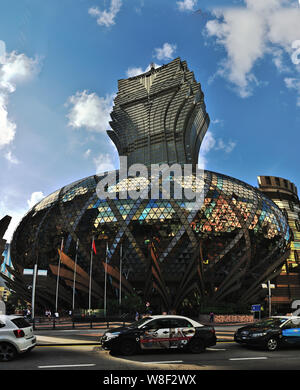 --FILE--Cars drive past the Grand Lisboa casino in Macau, China, 3 June 2015.    Macau casino operators are leading gains on Hong Kong's stock market Stock Photo