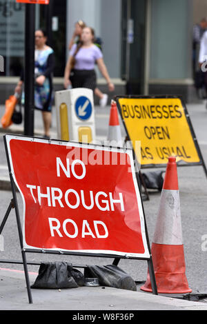 London, England, UK. Traffic signs at roadworks in Central London : No through road, but Businesses open as usual Stock Photo