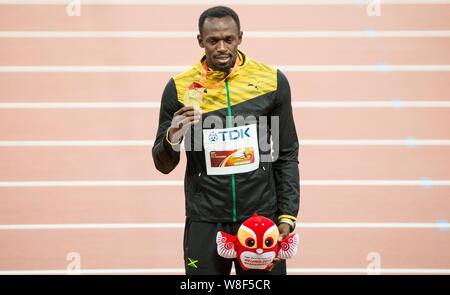 Jamaica's Usain Bolt poses with his gold medal on the podium after winning the men's 200m final during the Beijing 2015 IAAF World Championships at th Stock Photo