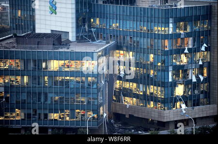 Windows of office buildings near the blast site are shattered by shockwaves from the deadly explosions in Binhai New Area in Tianjin, China, 13 August Stock Photo