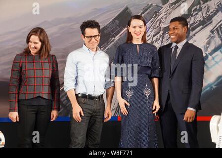 (From second left) American director J. J. Abrams, English actress Daisy Ridley and actor John Boyega pose during a press conference for their movie ' Stock Photo