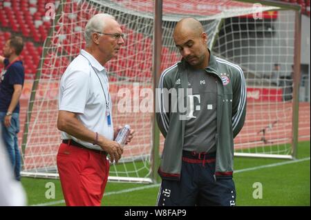 Head coach Pep Guardiola of Bayern Munich FC, right, and German football manager Franz Beckenbauer, left, attend a training session for the Audi Footb Stock Photo