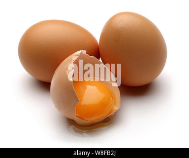 Broken chicken eggs with yolk isolated on white background Stock Photo