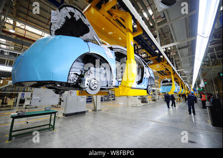 Chinese workers assemble Ford SUVs on the assembly line at the auto ...