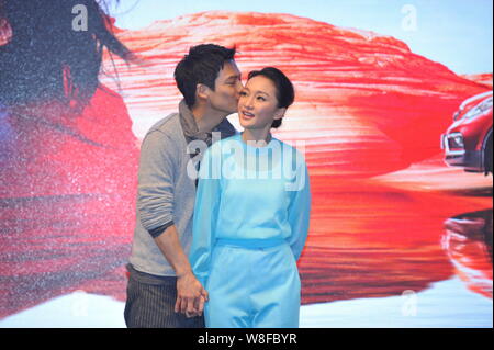 Chinese actress Zhou Xun, right, is kissed by her American actor husband Archie Kao during a premiere event for the micro film 'Dream Escape' to promo Stock Photo