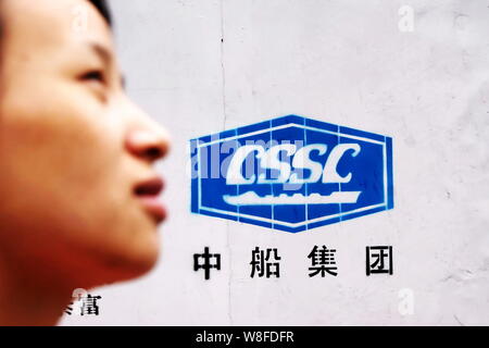 --FILE--A pedestrian walks past a logo of China State Shipbuilding Corporation (CSSC) in Shanghai, China, 17 April 2012.    China CSSC Holding Ltd, a Stock Photo