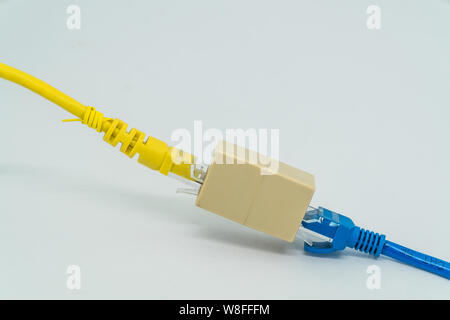 Blue and Yellow ethernet Cat5e cables plug RJ45 cable extender on a white background Stock Photo