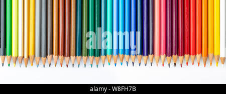 Colored pencils texture. Foreground. All the range of colors of the rainbow. Start of school Beautiful wallpaper. Isolated on white background. Stock Photo