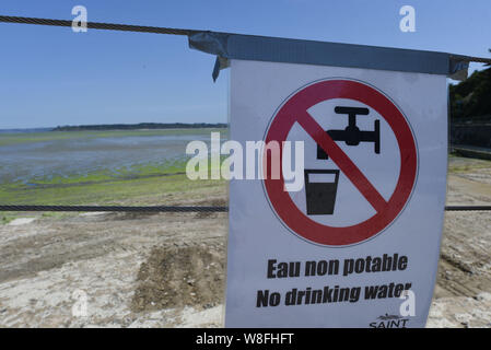 *** STRICTLY NO SALES TO FRENCH MEDIA OR PUBLISHERS *** July 16, 2019 - Saint-Brieuc, France: A sign warning people not to drink water from this tap located on beach du Valais, which has been closed due to a surge of potentially toxic green algae. Stock Photo