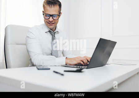 Successful handsome businessman working in his office Stock Photo