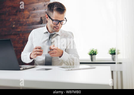 Successful handsome businessman working in his office Stock Photo