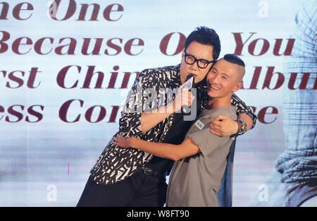 South Korean singer Jeong Soon-won, left, better known by his stage name The One, poses with a fan during a press conference for his Chinese album 'Be Stock Photo