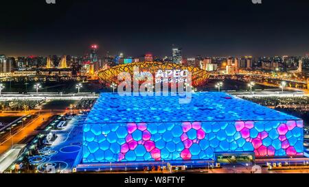 Night view of the Beijing National Stadium, back, also known as the Bird's Nest, and the Beijing National Aquatics Center, also known as the Water Cub Stock Photo