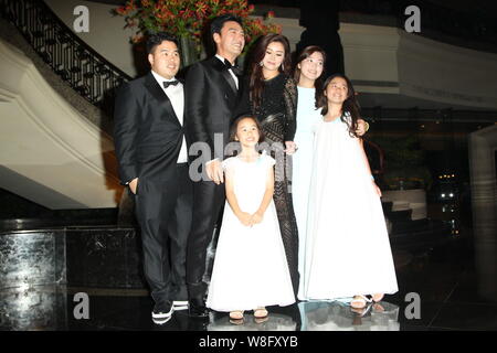 Hong Kong actor Kenny Bee, second left, his wife Fan Jiang and their children pose as they arrive for their wedding party in Hong Kong, China, 22 May Stock Photo