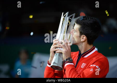 Novak Djokovic of Serbia kisses his trophy at the award ceremony after defeating Jo-Wilfried Tsonga of France in their final match of the men's single Stock Photo