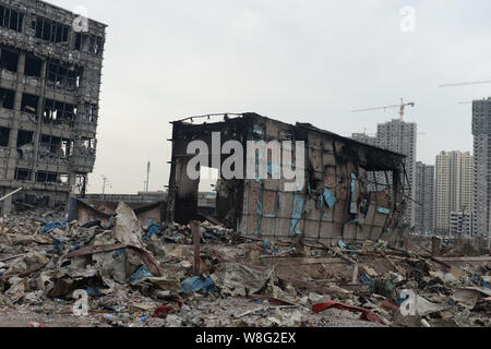 Buildings are burnt out at the blast site after the deadly explosions in Binhai New Area in Tianjin, China, 14 August 2015.   Death toll from the mass Stock Photo