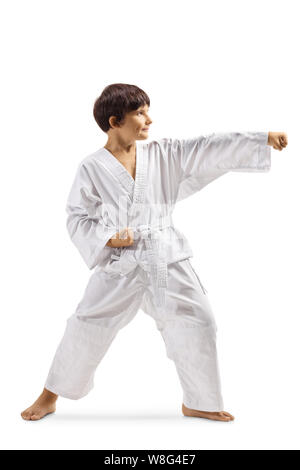 Full length shot of a boy in a white kimono practicing martial arts isolated on white background Stock Photo