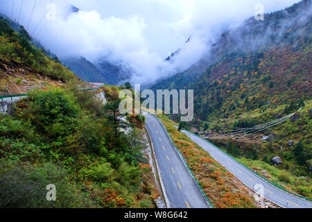 --FILE--Landscape of the China National Highway 318 through mountains near Zhangmu town, Nyalam county, Shigatse, southwest China's Tibet Autonomous R Stock Photo