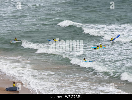Bournemouth, UK. 9th Aug, 2019. Surfers and RNLI staff make the most of the very windy weather in Bournemouth in August. Credit: Thomas Faull/Alamy Live News Stock Photo