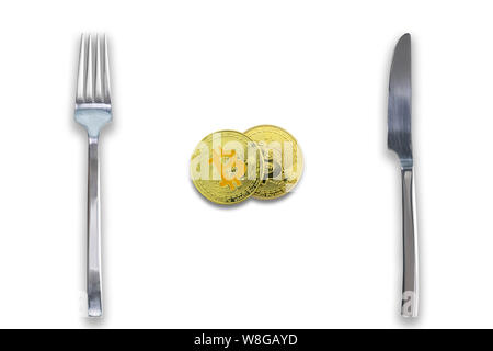 Two Bitcoins crypto currency between fork and knife. Concept of Bitcoin scalability problem. Cryptocurrency market deficit and limitations. Isolated w Stock Photo