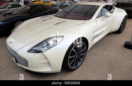 Three-quarters front view of an Aston Martin One-77, on display in the International Paddock, at the 2019 Silverstone Classic Stock Photo